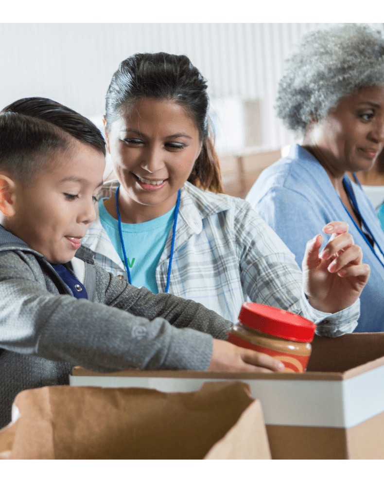 hispanic family and black woman helping pack food for the homeless